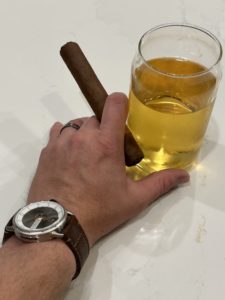 Timeless Swiss watch with cigar and hard cider